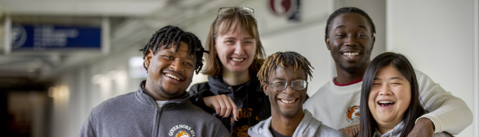 Students smiling in campus hallway